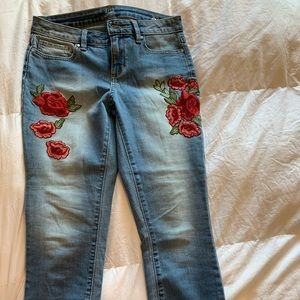 Light wash jeans with red flowers